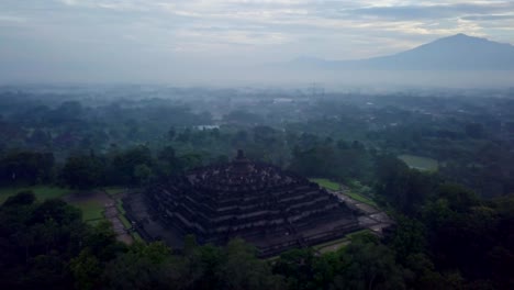 Tiro-de-drone-de-vista-aérea-del-templo-de-Borobudur-en-Java-al-amanecer,-viajes-Indonesia-religión-drone-concepto-4K-de-resolución