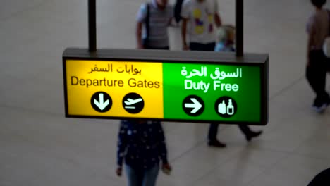 Blured-Departure-board-and-duty-free-sign-at-the-airport