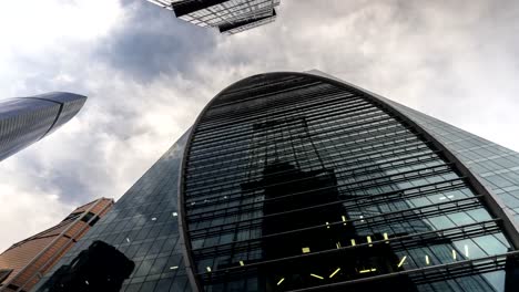 bottom-up-view-of-rotating-skyscrapers-and-flying-clouds,time-lapse,-hyper-lapse