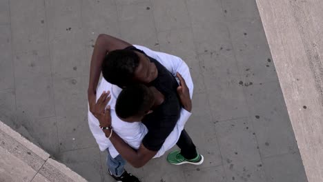 Two-young--african-men-hugging-in-the-street