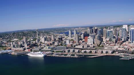 Helicopter-Filming-Seattle-Oceanfront-Cityscape-on-Sunny-Day