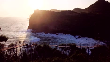 4K-abejón-aéreo-de-puesta-de-sol-en-terreno-montañoso-en-Pulau-Timang.