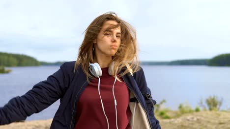 A-teenage-girl-dances-on-the-river-bank.