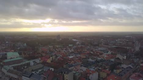 Aerial-view-of-Lund-city-and-Cathedral-church-building-at-sunset.-Drone-shot-flying-down-over-cityscape-skyline-and-church-tower-spire