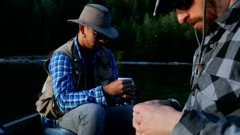 Two-fishermen-preparing-for-fishing-in-the-boat-4k