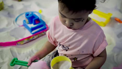 Little-girl-playing-in-a-sandbox