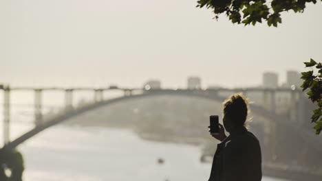 women-in-silhouette-taking-selfie-on-smartphone-in-city-park