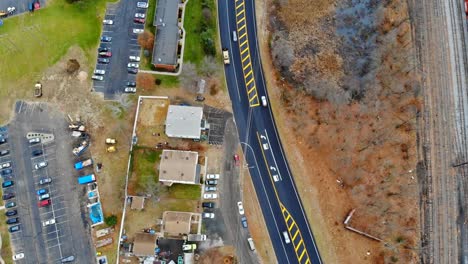 Aerial-view-of-an-housing-estate-on-the-city-with-railway-tracks-close-to-the-buildings,-drones-shot-a-height-for-your-design