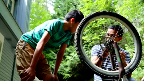 Father-and-son-repairing-bicycle-4k