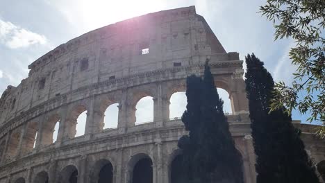 A-ray-of-sun-passes-through-the-arches-of-the-Colosseum-in-Rome,-Italy.