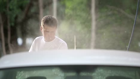 man-in-a-t-shirt-white-car-washes.-Slow-motion