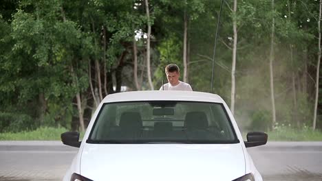 man-in-a-t-shirt-white-car-washes.-Slow-motion