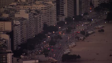 Busy-city-street-by-Copacabana-Beach-at-dusk,-Rio-de-Janeiro,-Brazil