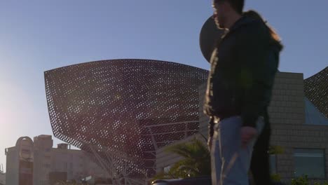 sunset-light-barcelona-beach-fish-gold-monument-close-up-4k-spain