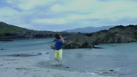 4k-Shot-of-a-Boy-Running-on-the-Beach