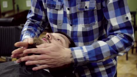 Barber-is-drying-beard-a-bearded-man-with-hairdryer-in-a-barber-shop