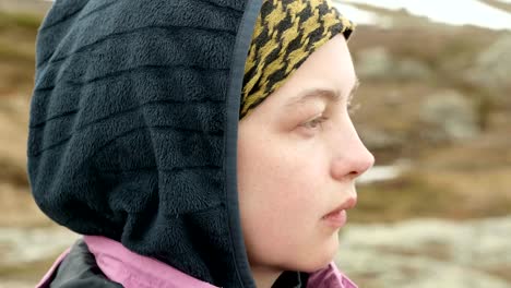 Young-woman-face-on-a-background-of-mountains