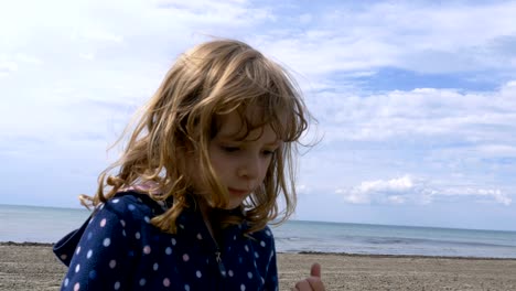 Little-Girl-on-the-Shores-of-Lake-Ontario-Playing-with-Pebbles