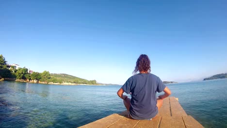 4K-beach-yoga-LOOP,-caucasian-girl-on-a-dock-quad-HD,-LOOP