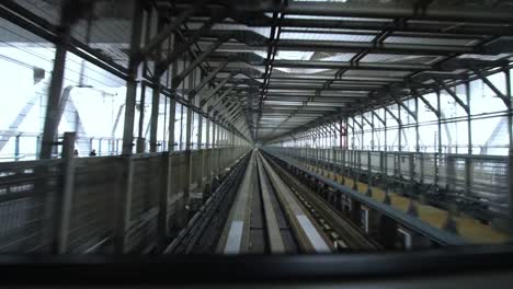 High-speed-bullet-train-going-a-modern-bridge-in-downtown-center-in-Tokyo