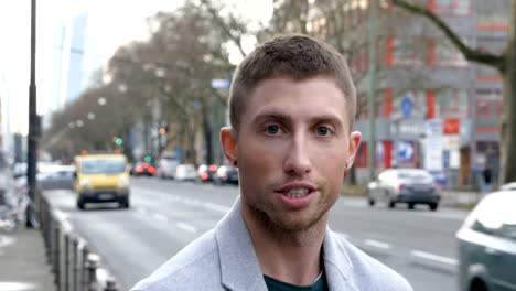 Head-Shot-of-a-Bewildered-Young-Man-on-City-Street