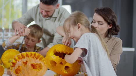 Cute-Girl-Making-Jack-o-Lantern-with-Family