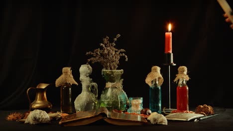 Lighting-candlestick-on-table-with-witchcraft-objects