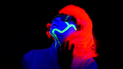 Woman-with-UV-cyborg-face-paint,-wig,-glowing-clothing-portrait-dancing-hard.-Asian-woman.-.