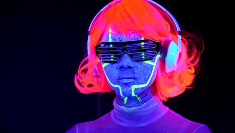 Woman-with-UV-face-paint,-wig,-glowing-glasses,-clothing-portrait,-camera-tilt-upward-to-her-face.-Asian-woman.-.