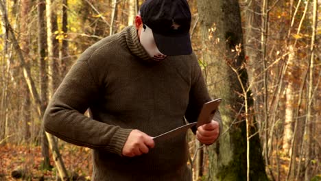 Man-in-Halloween-mask-sharpening-knives