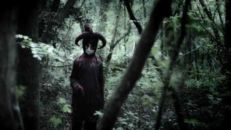 4k-Halloween-Shot-of-a-Child-in-Joker-Costume-Standing-in-Forest