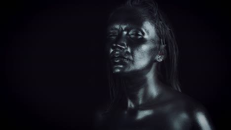 4K-Horror-Woman-with-Silver-Metallic-Make-up-Posing-like-Statue