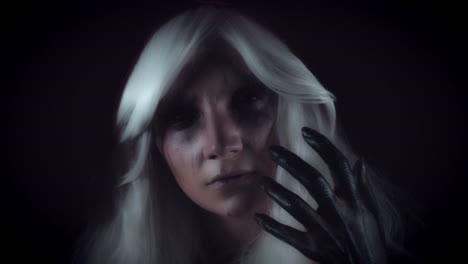 4K-Horror-Witch-Gesturing-with-Hand-and-Appearing-from-Darkness