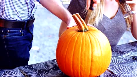 Man-carving-a-pumpkin-to-make-halloween-lantern