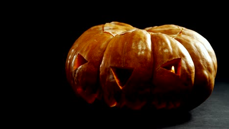 Halloween-pumpkin-against-black-background-4k