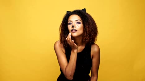 Beautiful-african-woman-smarten-up-her-hair-and-smiling-at-mirror-isolated