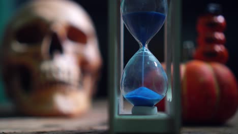 Halloween-sandglass-with-human-skull-and-pumpkin