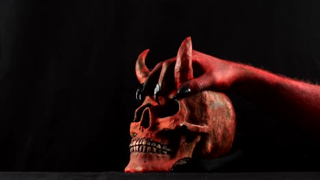 Red-demon-hand-touching-red-demon-skull.-50-fps