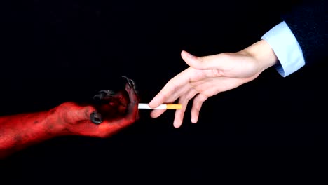 Demon-hand-gives-a-cigarette-to-the-man.-Top-view.-50-fps