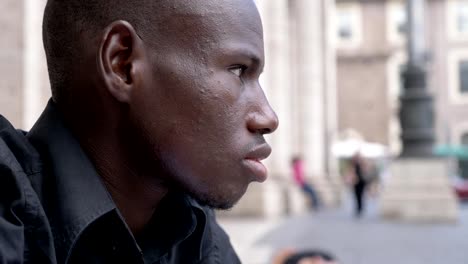 Confident-serious-young-black-man-turning-and-staring-at-camera--outdoor