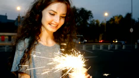 Teenage-Girl-Start-Sparklers-In-The-Night-Street-In-Front-Of-City-Lights