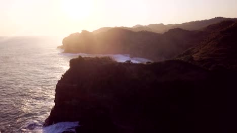 4K-aerial-drone-of-sunset-on-hilly-terrain-at-Pulau-Timang.