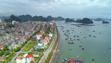 4k-Aerial-view-over-city-and-park-with-Bai-Tho-karst-mountain-Ha-long-bay.-Halong-City.