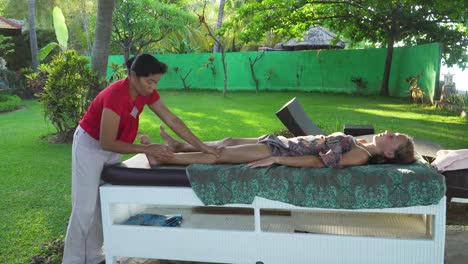 Woman-doing-massage-to-girl-in-asia.-Bali,Indonesia