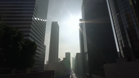 dolly-moving-shot-of-modern-skyscrapers-in-business-district-downtown-Los-Angeles,-California