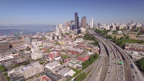 Rising-Aerial-of-Downtown-Seattle-Washington-with-Interstate-Freeway-and-Skyscraper-Buildings-in-Beautiful-Cityscape