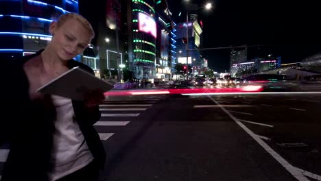 Timelapse-of-woman-with-tablet-PC-in-night-Seoul,-South-Korea