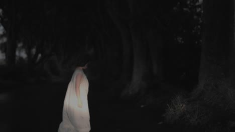 4k-Horror-Shot-of-a-child-in-Dark-Hedges,-N.-Ireland