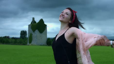 4k-Castle-in-Background-Shot-of-a-Woman-Spinning-Happy