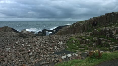 4k-Shot-of-Tourists-on-Giant's-Causeway,-Northern-Ireland